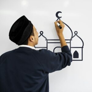 Young Muslim man writing on a whiteboard